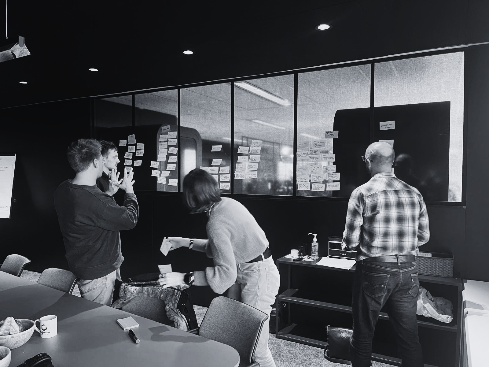 Team designing next actions on a sticky-note wall